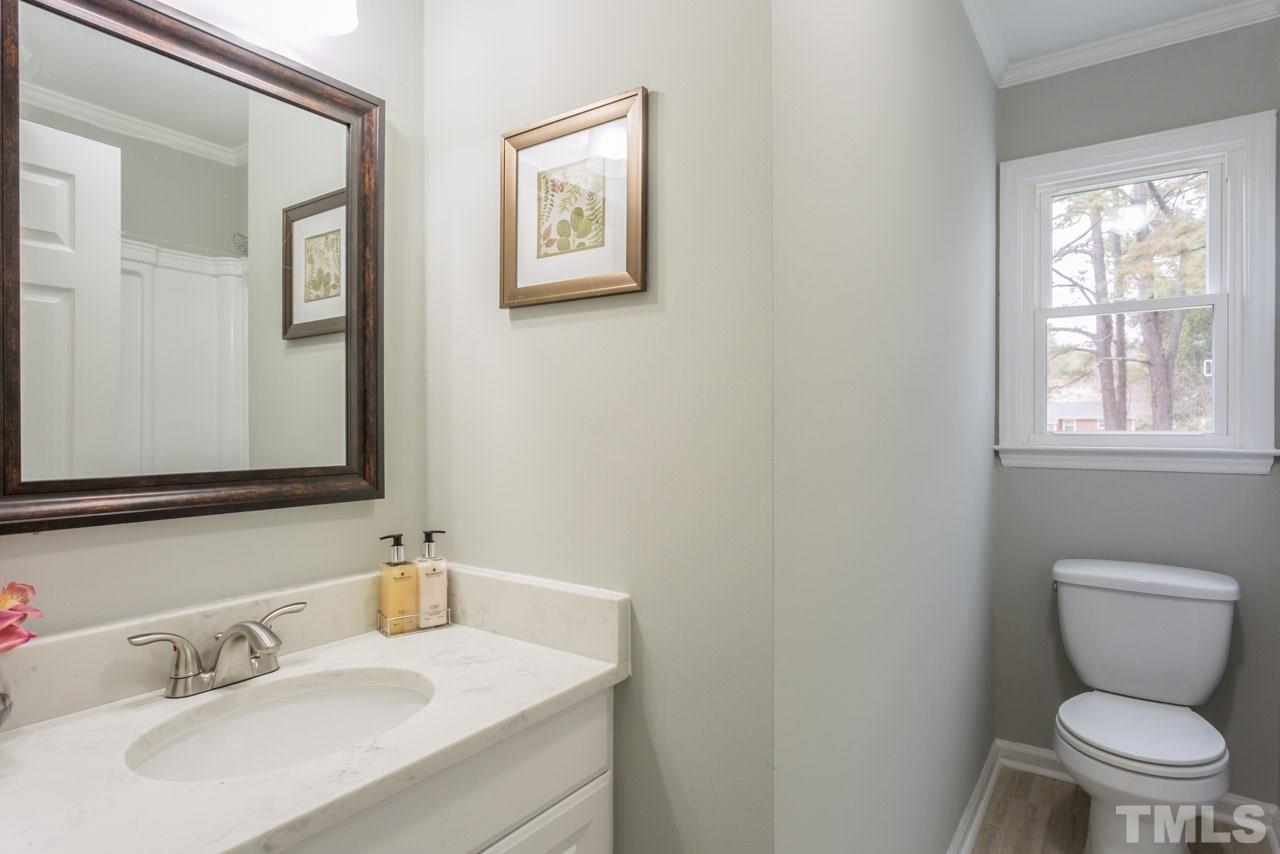 3822 Corwin Road Garner, NC 27529 - Photo 6 of 25 a bathroom with a toilet sink and mirror