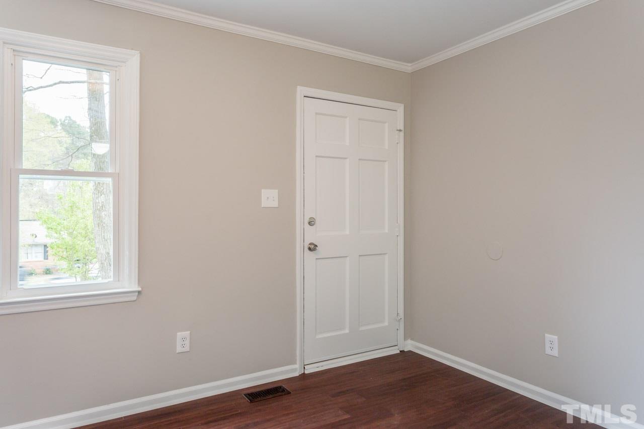 3822 Corwin Road Garner, NC 27529 - Photo 9 of 25 an empty room with wooden floor and windows