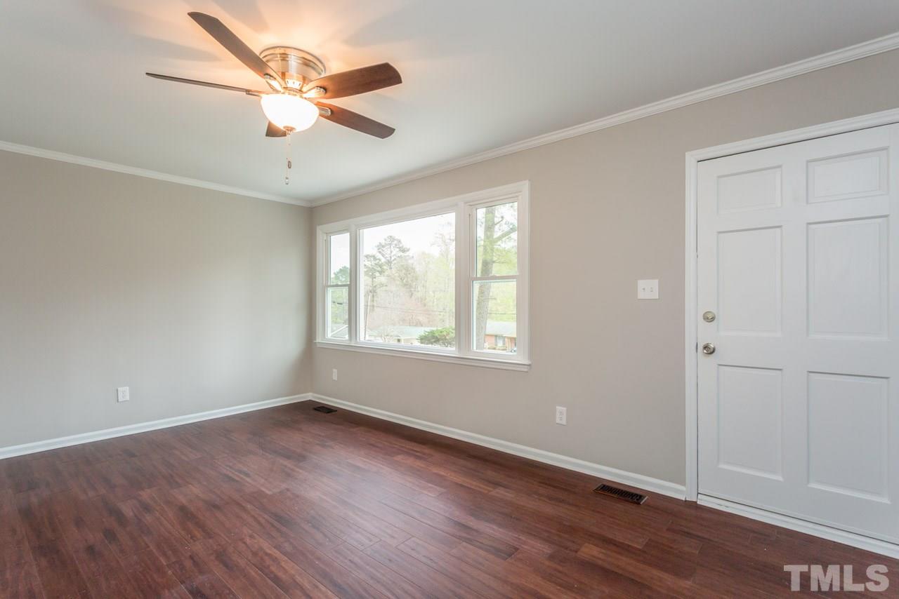 3822 Corwin Road Garner, NC 27529 - Photo 10 of 25 an empty room with wooden floor and windows