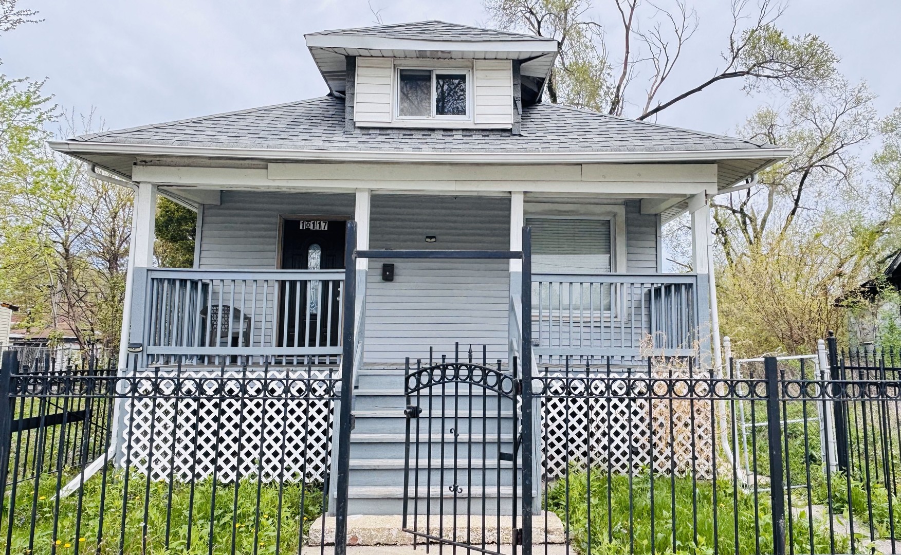 10117 South Perry Avenue Chicago, IL 60628 - Photo 1 of 33 a view of a house with a wooden deck