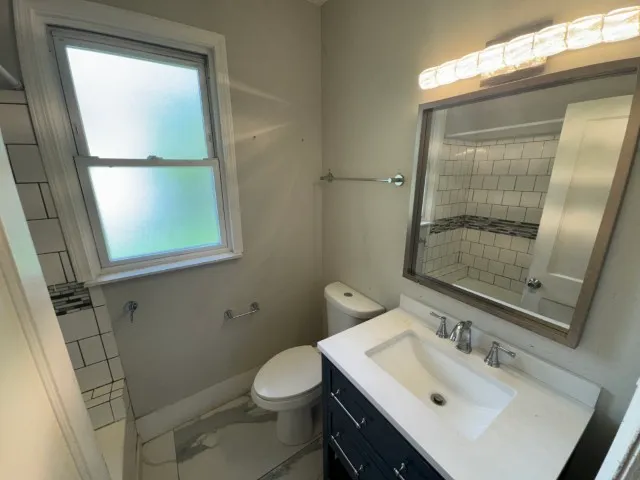a bathroom with a sink toilet and shower