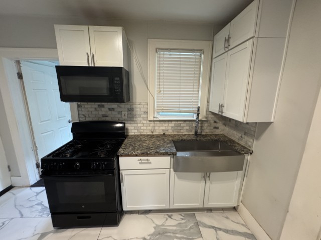 10117 South Perry Avenue Chicago, IL 60628 - Photo 18 of 33 a kitchen with granite countertop a sink and a stove top oven