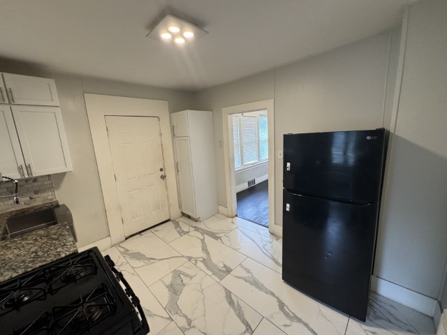 10117 South Perry Avenue Chicago, IL 60628 - Photo 20 of 33 a kitchen with a refrigerator and a stove