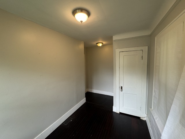 10117 South Perry Avenue Chicago, IL 60628 - Photo 25 of 33 an empty room with wooden floor