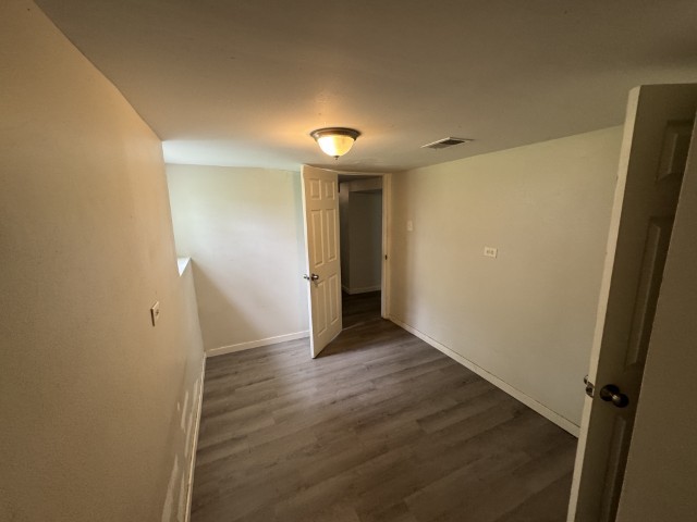 10117 South Perry Avenue Chicago, IL 60628 - Photo 32 of 33 an empty room with wooden floor and a entrance