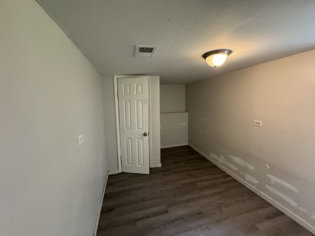 10117 South Perry Avenue Chicago, IL 60628 - Photo 33 of 33 an empty room with wooden floor and closet