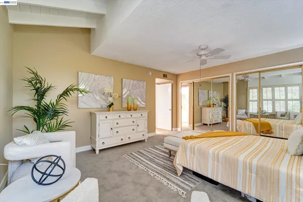 a bedroom with a bed dresser and a window