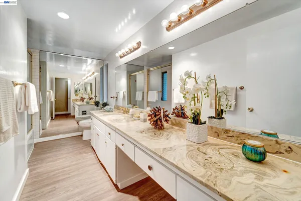 a large bathroom with double vanity sinks and a bathtub