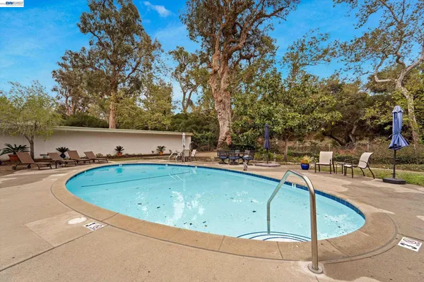 a view of a swimming pool with an outdoor seating