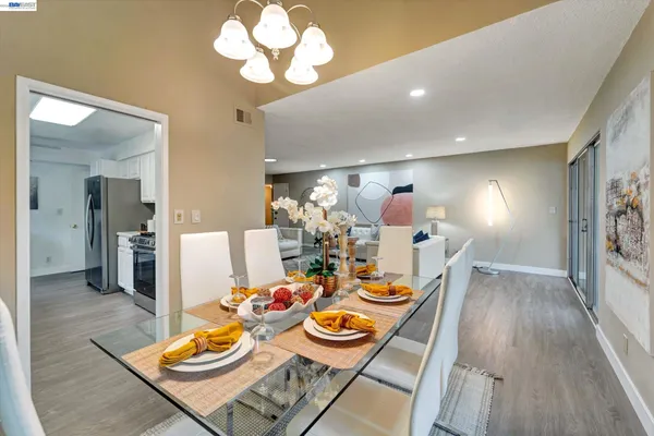a view of a dining room with furniture and wooden floor