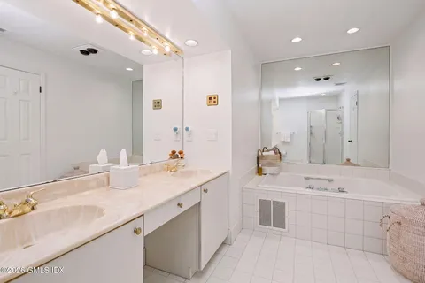 a bathroom with a sink double vanity and a mirror