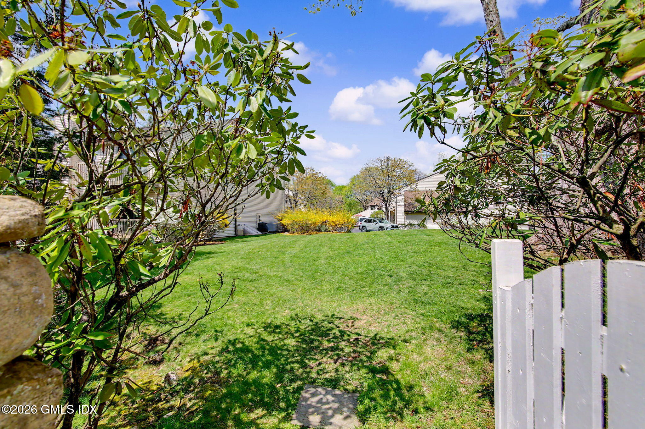 500 River Road, Unit 3 Cos Cob, CT 06807 - Photo 17 of 21 a view of a yard with plants and large trees
