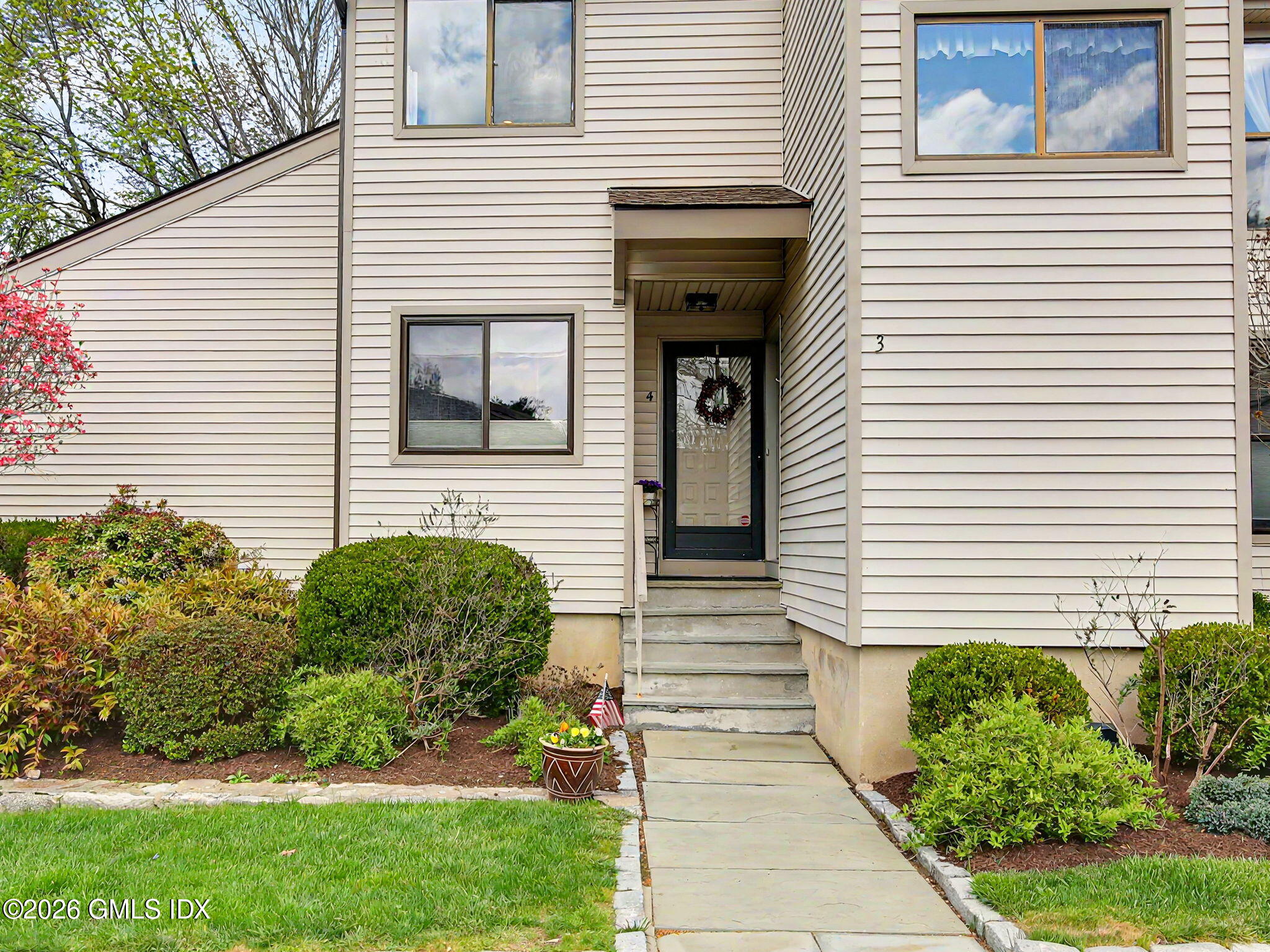 500 River Road, Unit 3 Cos Cob, CT 06807 - Photo 21 of 21 a view of a house with a small garden