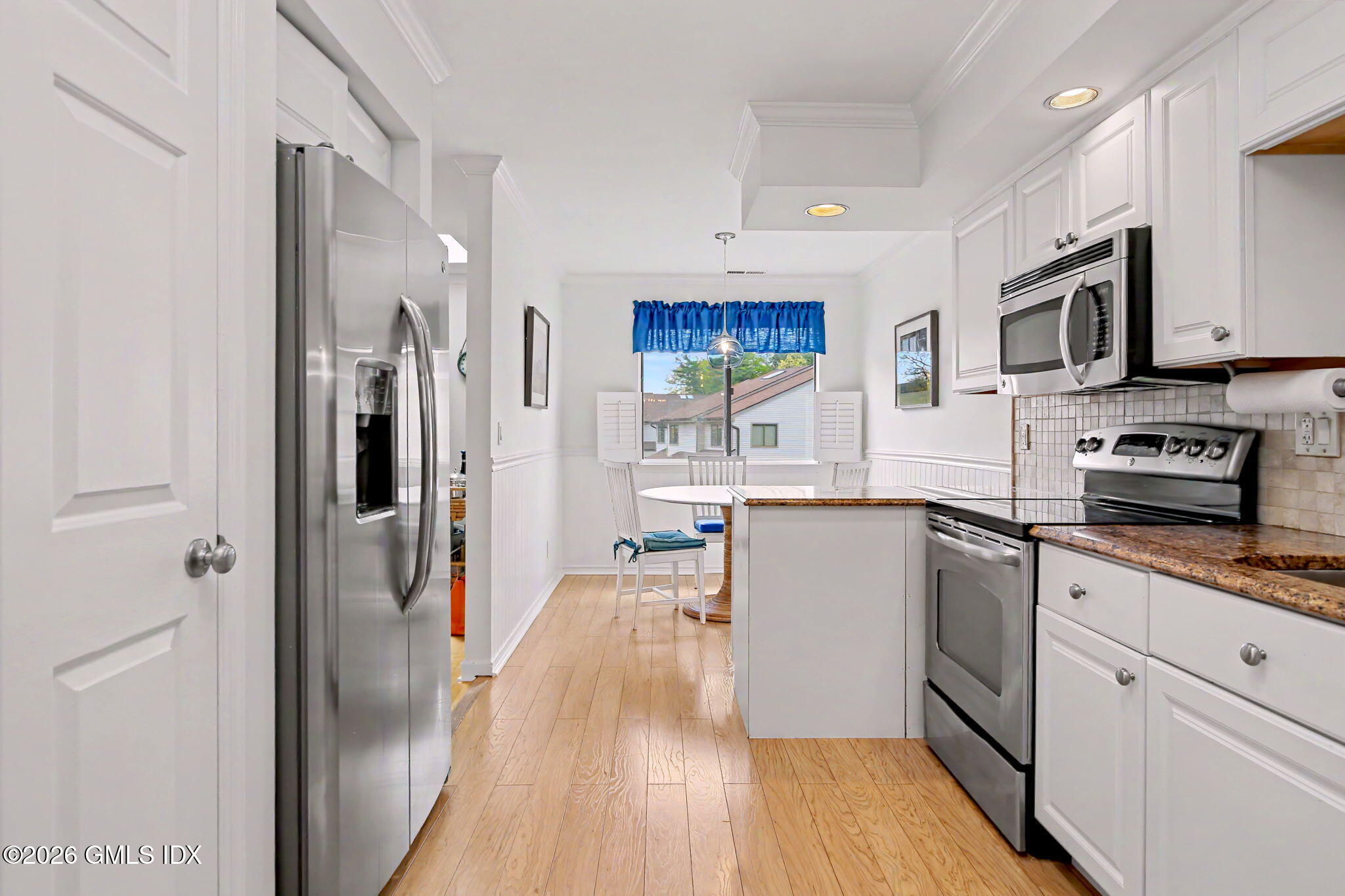 500 River Road, Unit 3 Cos Cob, CT 06807 - Photo 3 of 21 a kitchen with stainless steel appliances granite countertop a refrigerator a stove top oven a sink and dishwasher