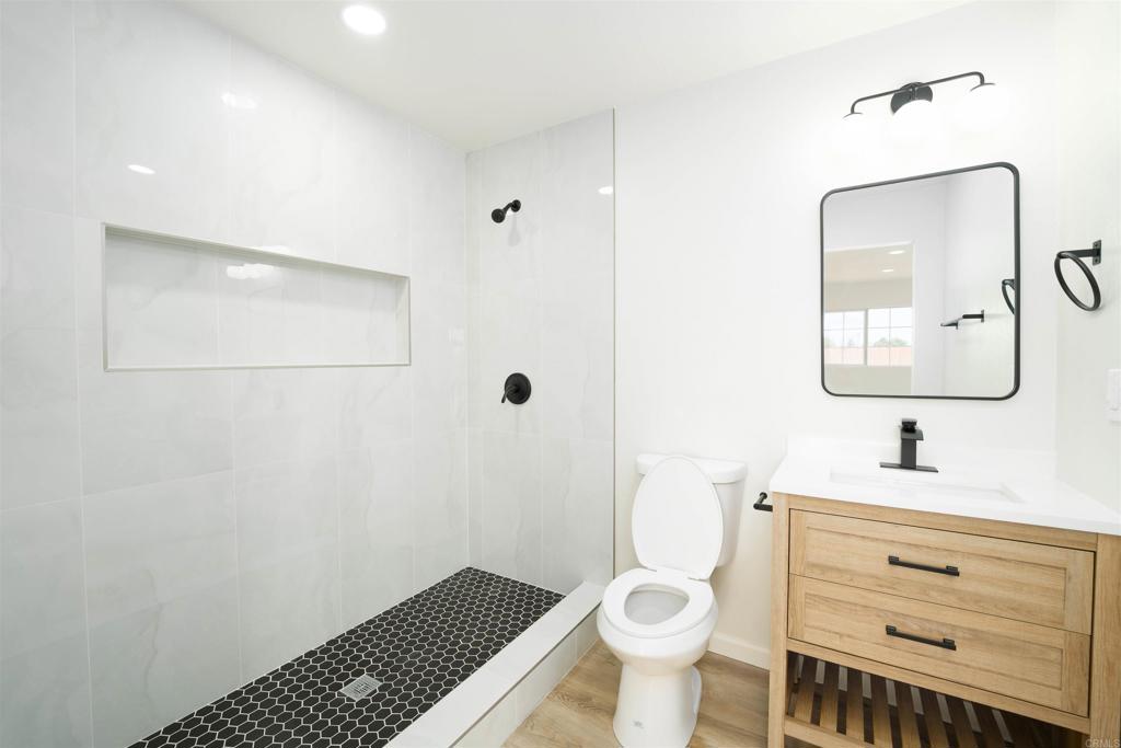 1314 Bluegrass Road Vista, CA 92083 - Photo 12 of 16 a bathroom with a sink toilet a mirror and vanity