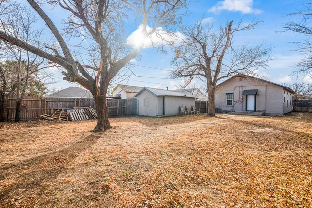 a house that has a tree in front of it