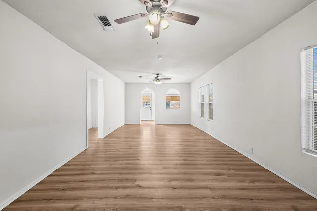 wooden floor in an empty room with a window