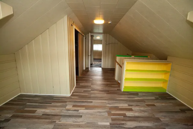 a view of a room with a wooden floor and a window