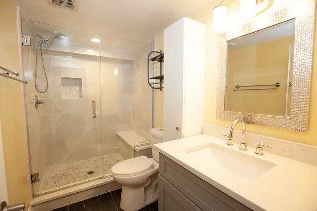 a bathroom with a sink toilet and shower