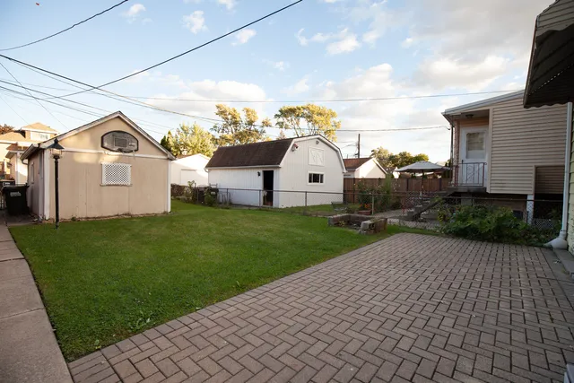 a view of a white house with a yard