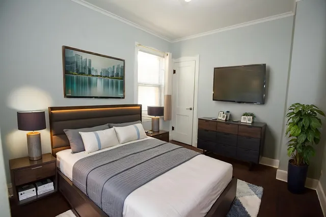 a bedroom with a bed and a flat screen tv