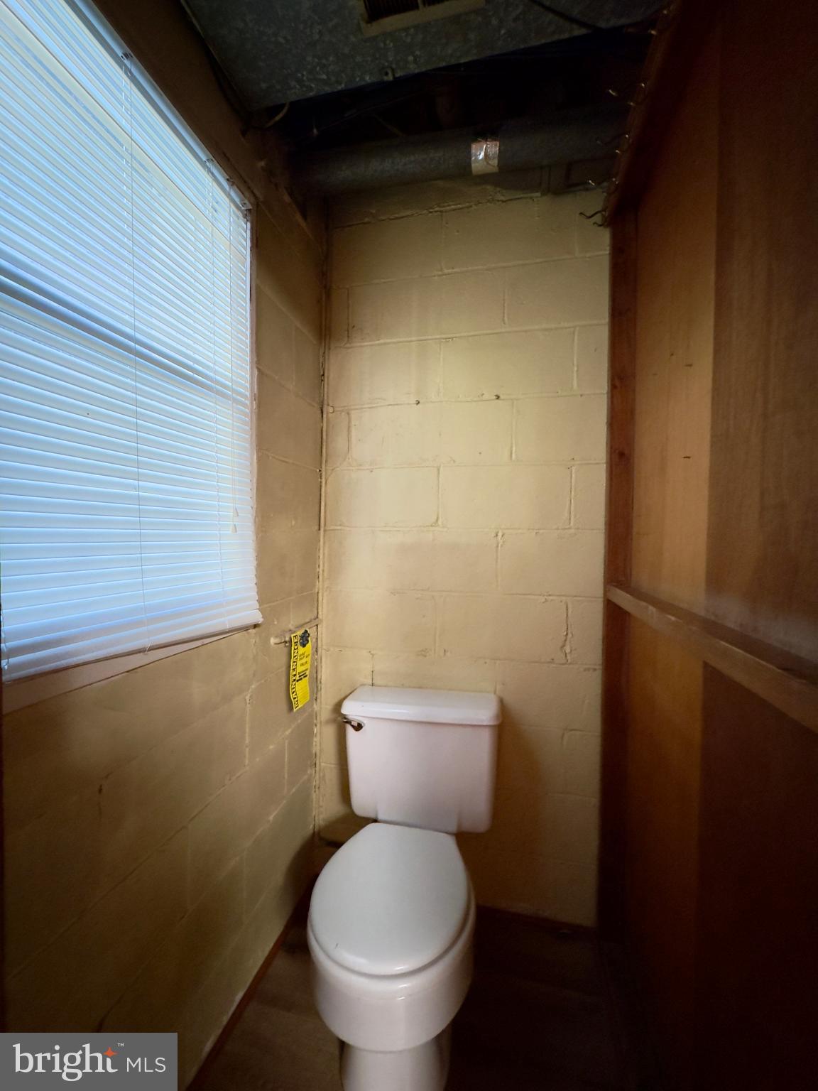 1011 Linden Avenue Baltimore, MD 21227 - Photo 15 of 20 a white toilet sitting next to a shower