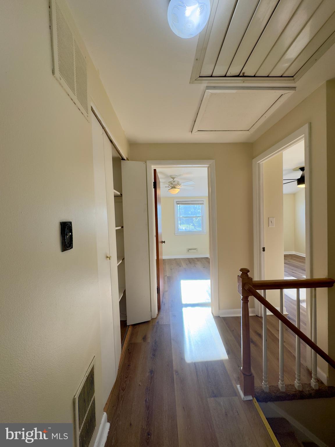 1011 Linden Avenue Baltimore, MD 21227 - Photo 18 of 20 a view of a hallway with wooden floor and staircase