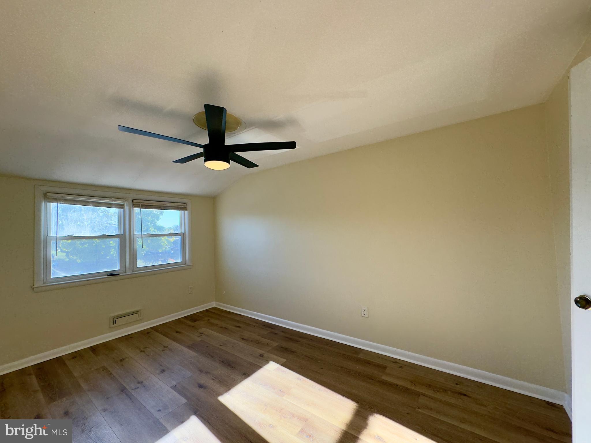 1011 Linden Avenue Baltimore, MD 21227 - Photo 20 of 20 an empty room with wooden floor and windows