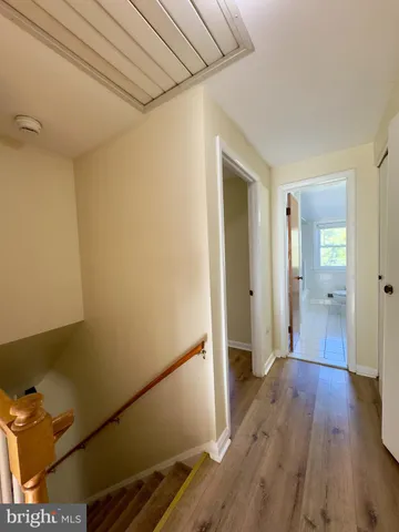 a view of hallway with wooden floor