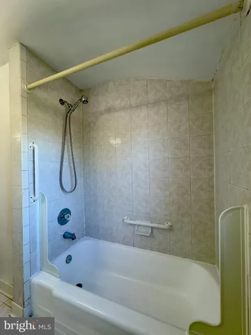 a bathroom with a bath tub with a shower