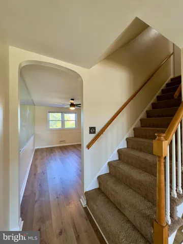 a view of entryway and hall with wooden floor