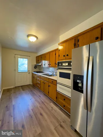 a kitchen with stainless steel appliances a refrigerator and a stove