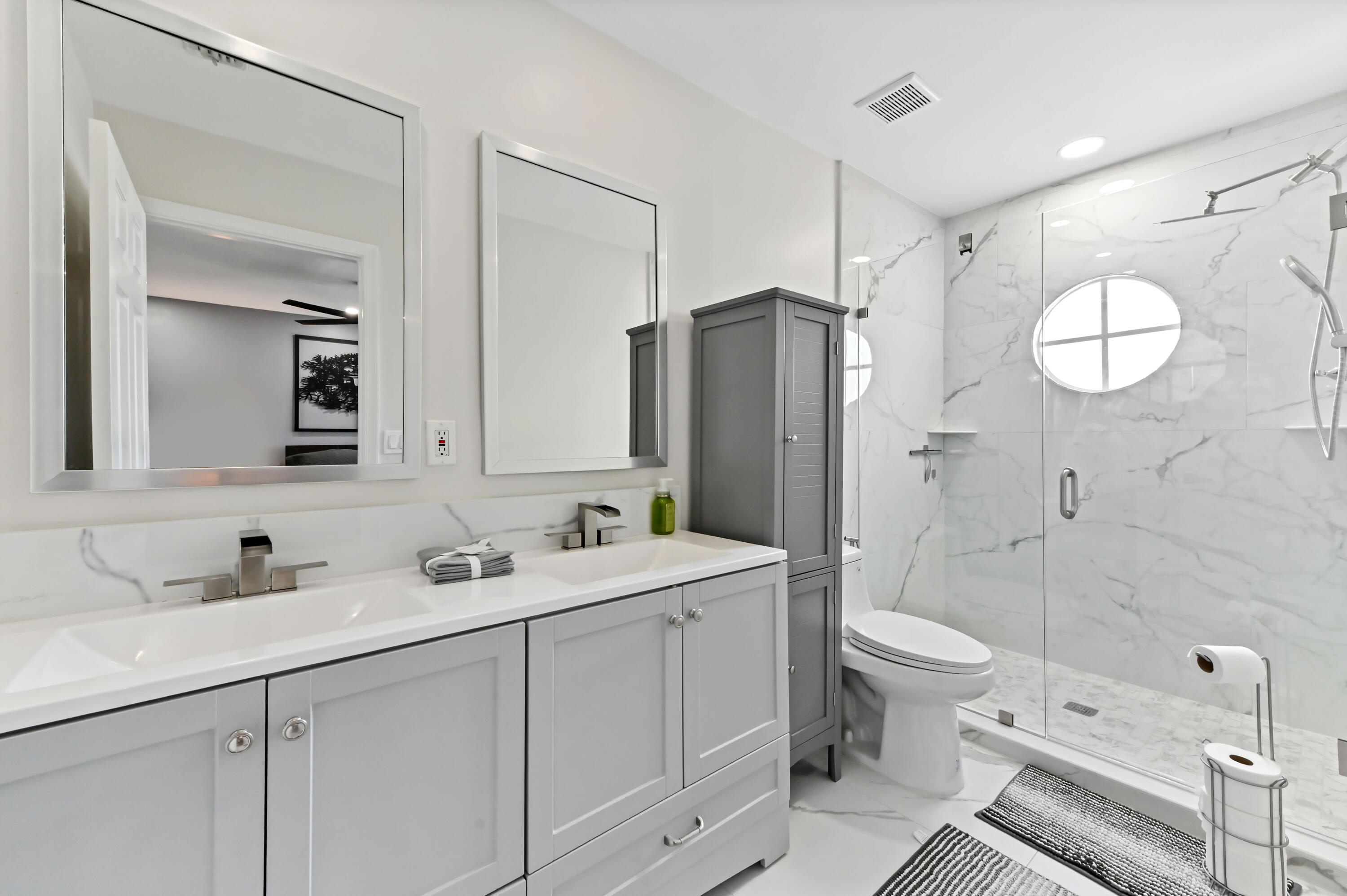 6880 Brook Hollow Road Lake Worth, FL 33467 - Photo 11 of 31 a spacious bathroom with a double vanity sink toilet mirror and shower