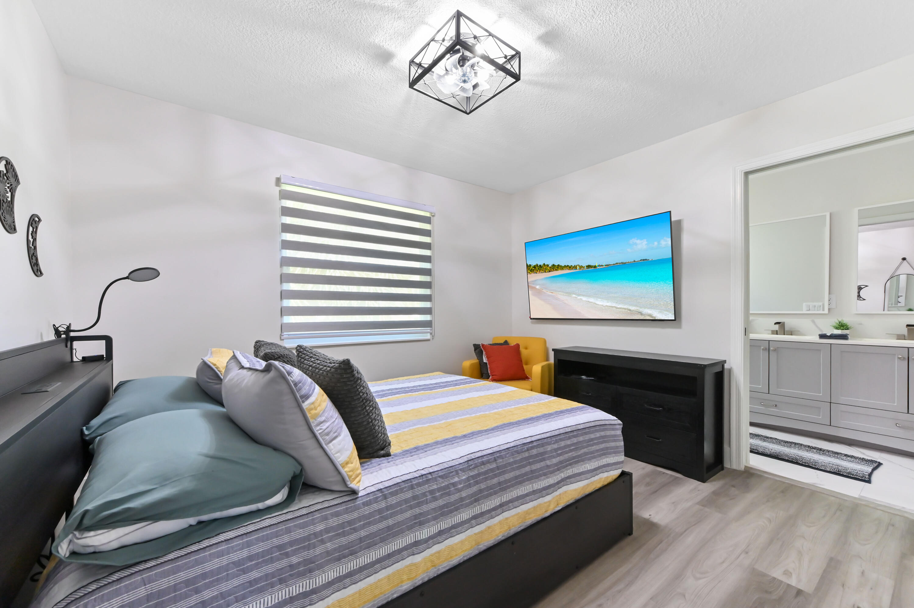 6880 Brook Hollow Road Lake Worth, FL 33467 - Photo 17 of 31 a bedroom with a bed and dresser