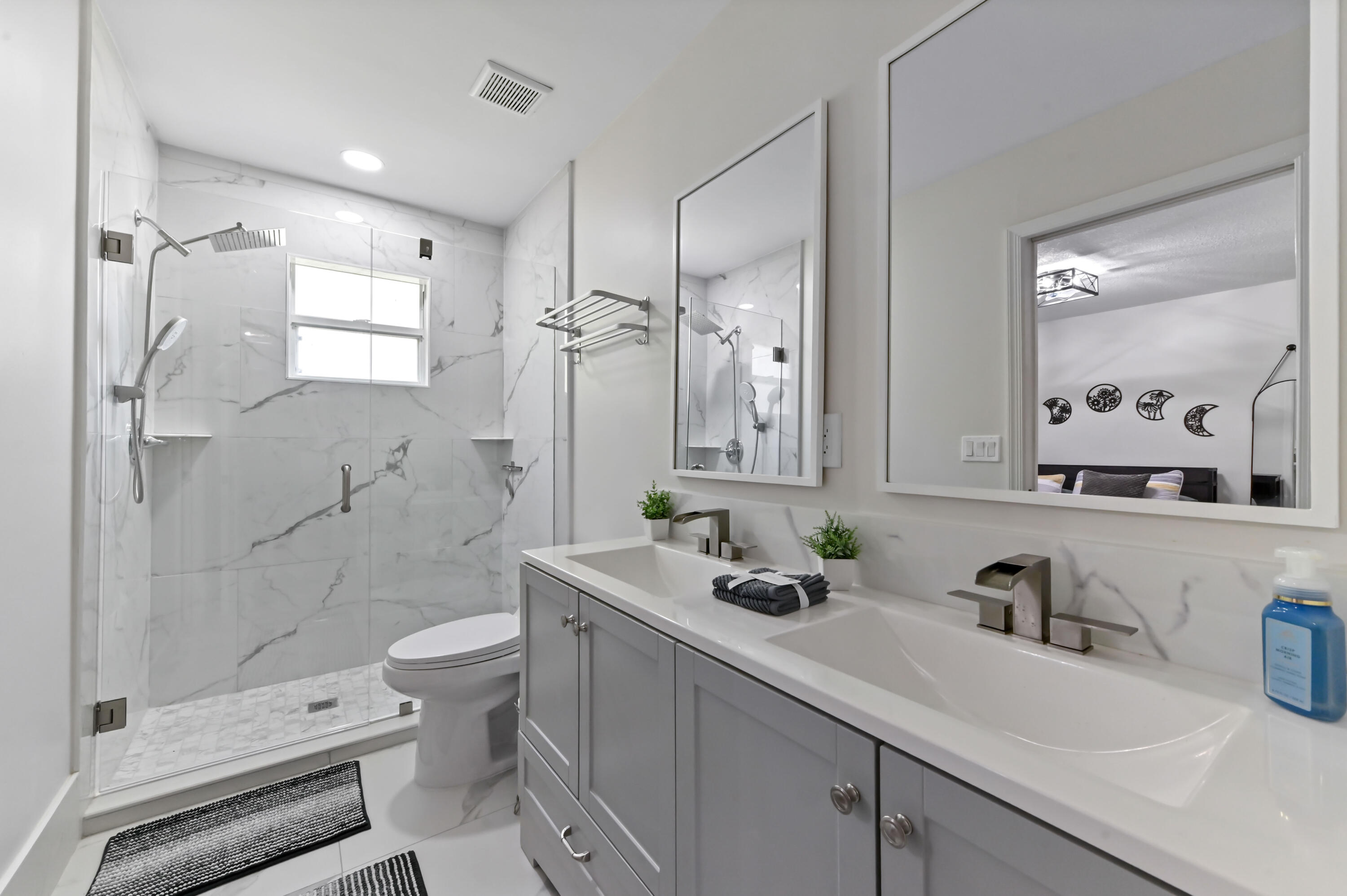 6880 Brook Hollow Road Lake Worth, FL 33467 - Photo 19 of 31 a bathroom with a double vanity sink toilet and shower