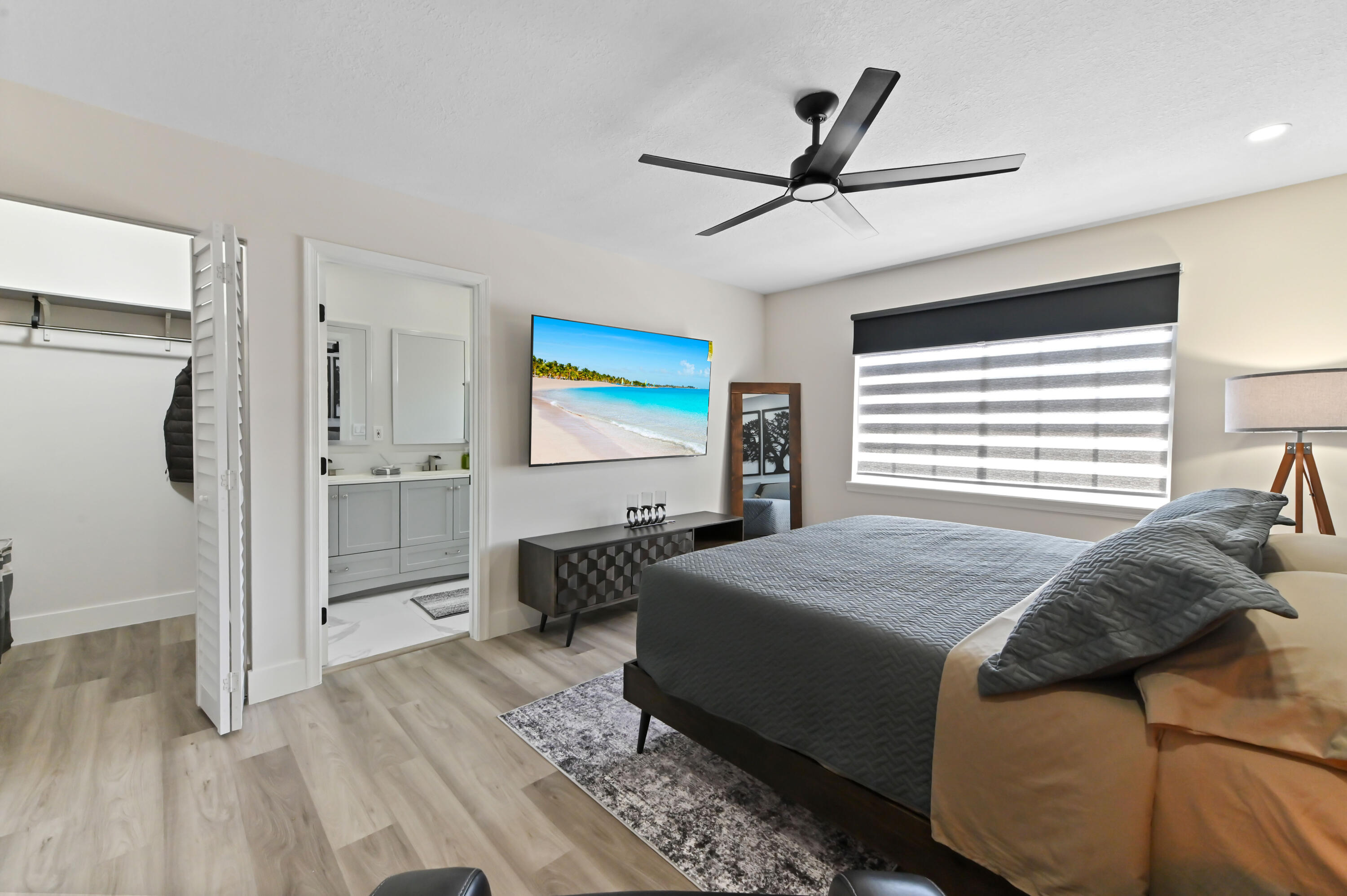 6880 Brook Hollow Road Lake Worth, FL 33467 - Photo 22 of 31 a bedroom with a bed and a chandelier