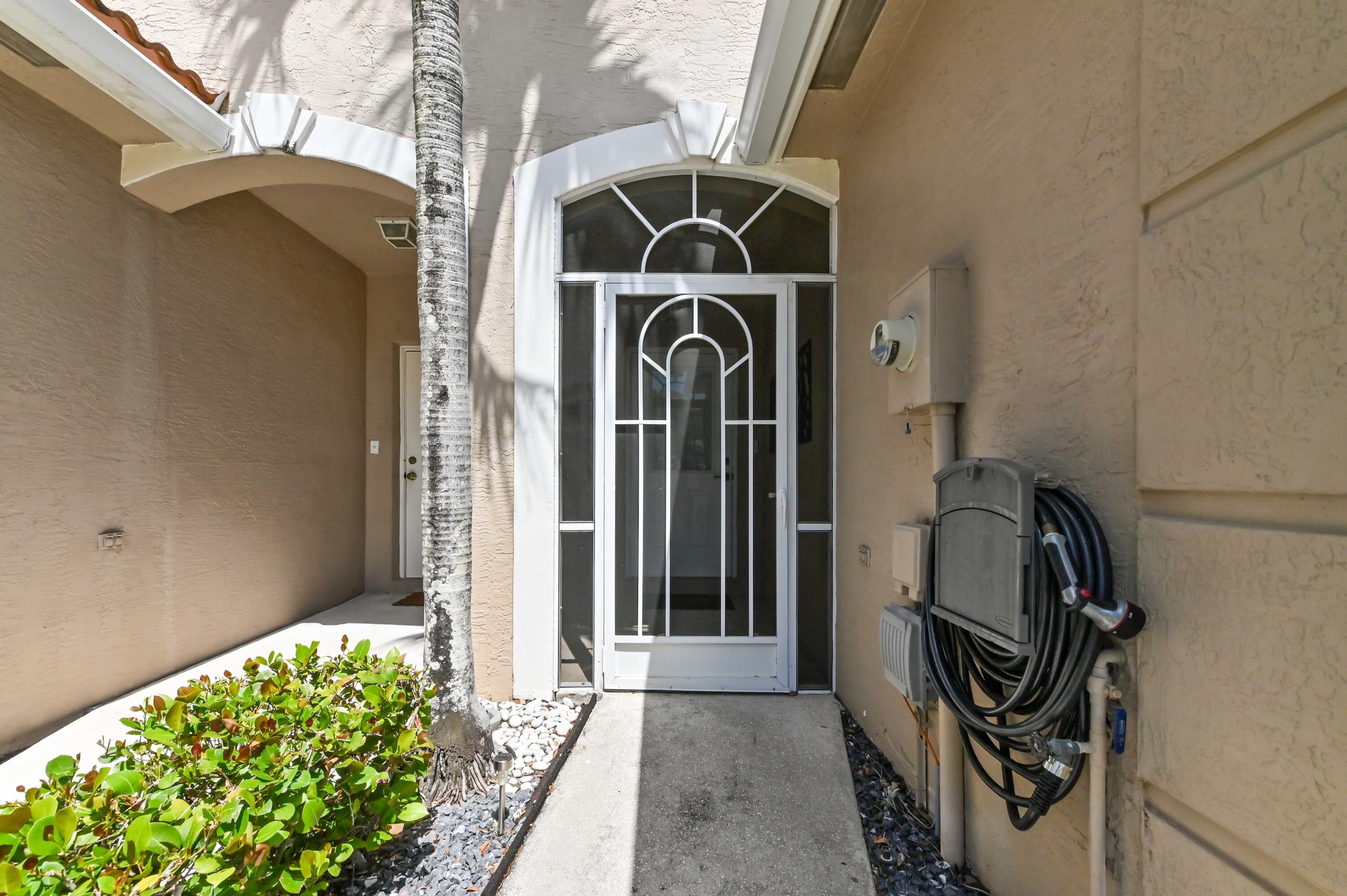 6880 Brook Hollow Road Lake Worth, FL 33467 - Photo 26 of 31 a front view of a house with garden