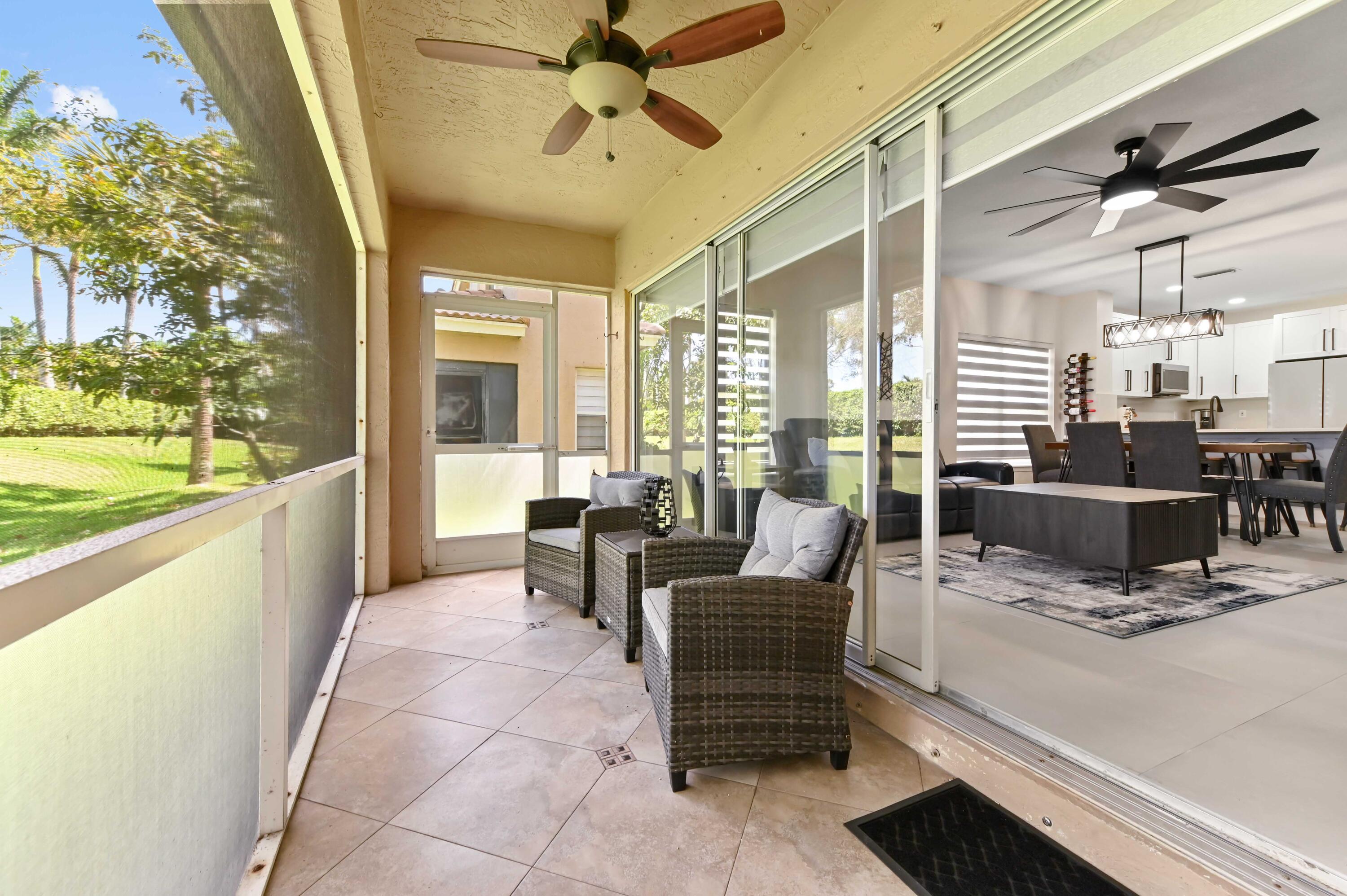 6880 Brook Hollow Road Lake Worth, FL 33467 - Photo 29 of 31 a living room with furniture and a large window