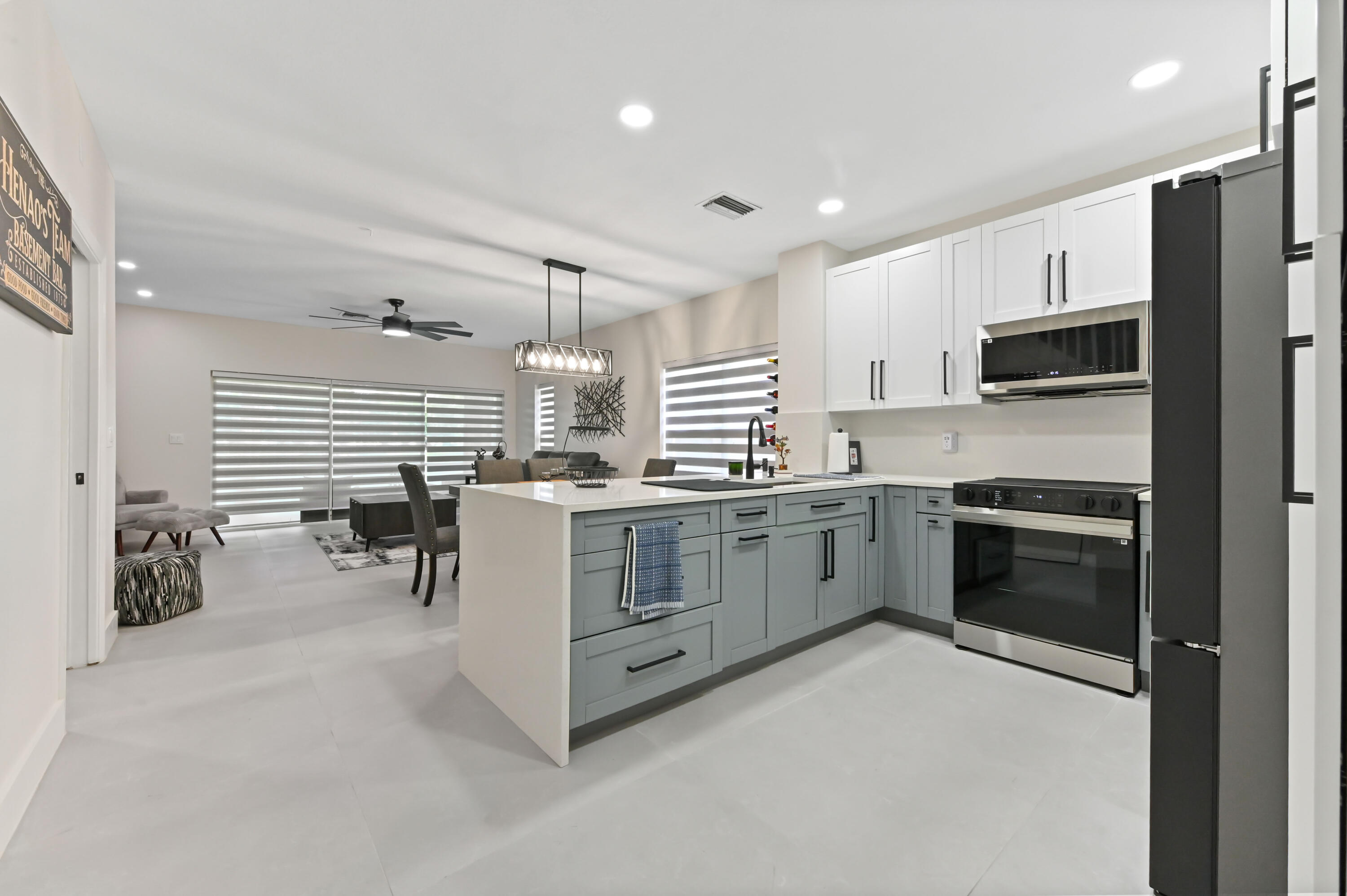 6880 Brook Hollow Road Lake Worth, FL 33467 - Photo 4 of 31 a kitchen with stainless steel appliances a stove sink microwave and cabinets