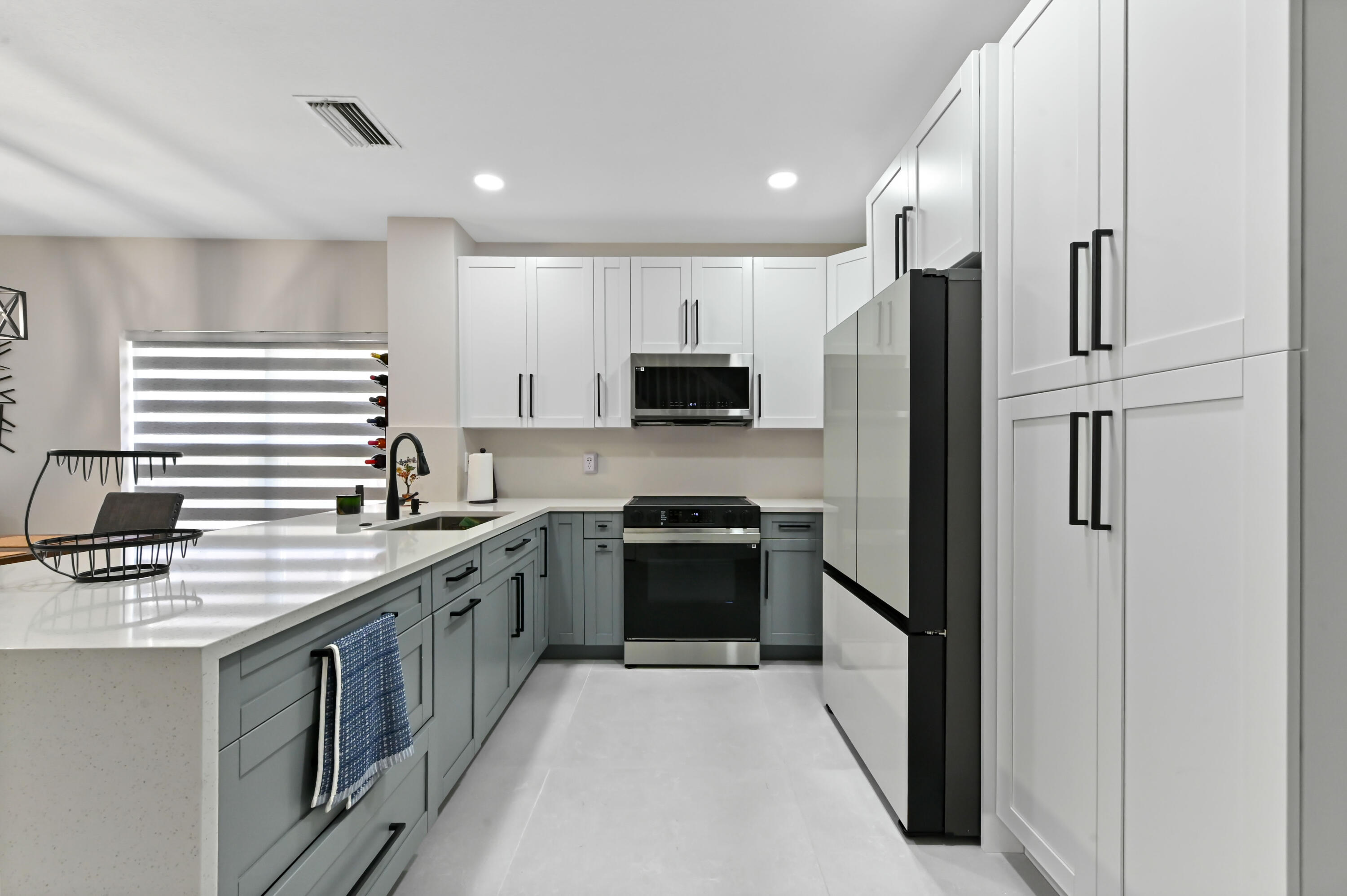 6880 Brook Hollow Road Lake Worth, FL 33467 - Photo 7 of 31 a kitchen with stainless steel appliances granite countertop a stove a sink and a refrigerator