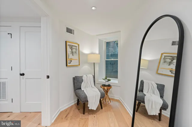 a living room with furniture and a mirror