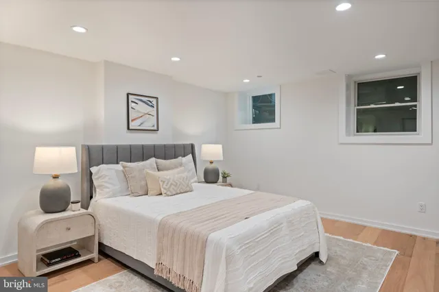 a bedroom with a bed and a painting on the wall