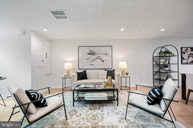 a bedroom with furniture and a large window