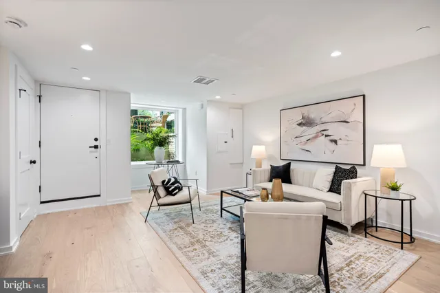 a living room with furniture and white walls