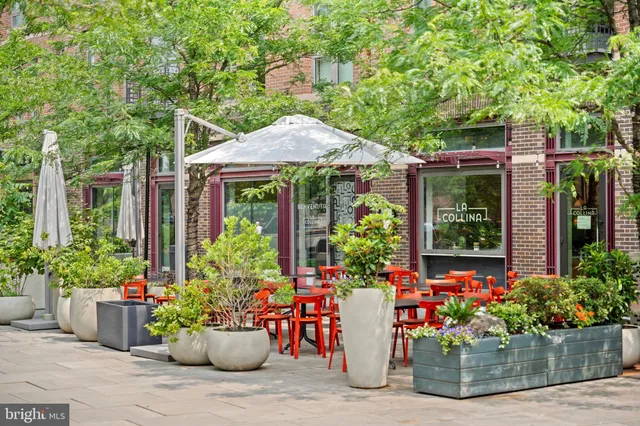 a front view of a building with potted plants