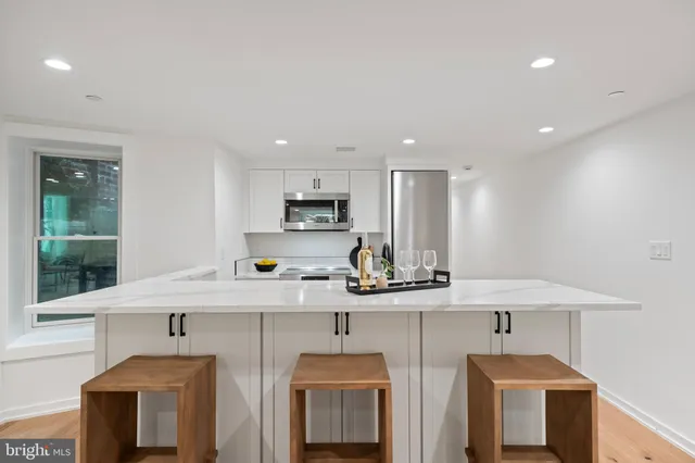 a kitchen with stainless steel appliances a sink stove and cabinets