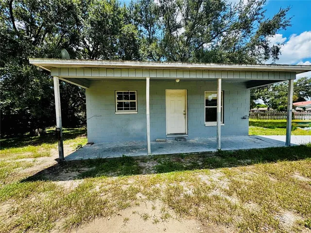 a view of a house with swimming pool next to a yard