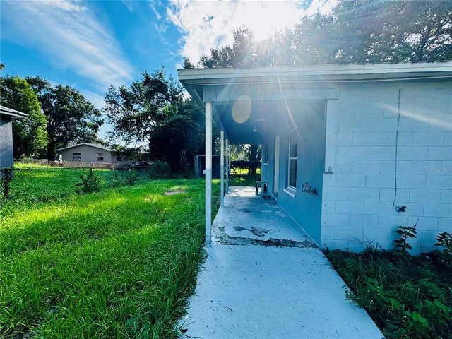 a view of a back yard of the house and a yard