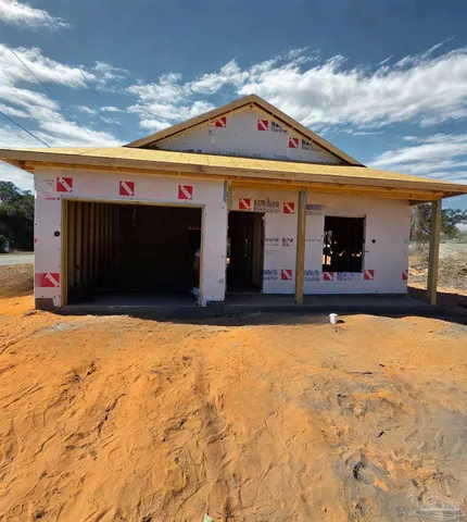 a front view of house with yard and garage