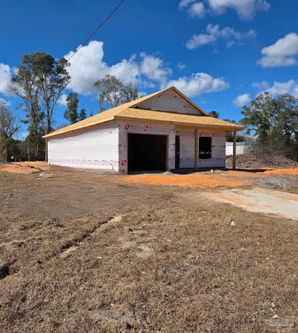 a front view of a house with yard and garage